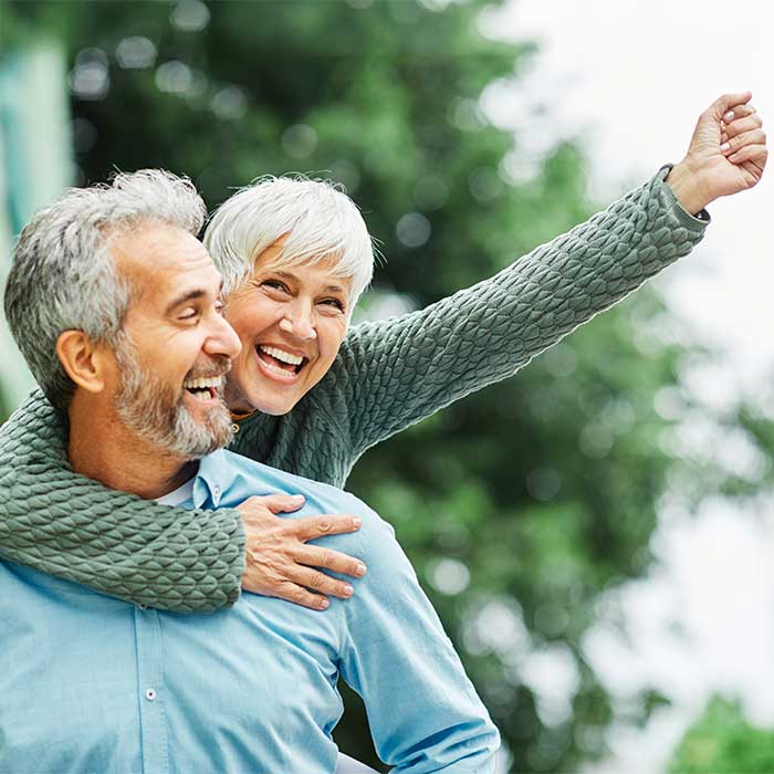 woman man outdoor senior couple happy lifestyle retirement together smiling love piggyback active mature Ohio Medicare Planning Professionals | No Cost to you, Zero Premium Plan Specialist, Local Experienced Advisors In Your Area